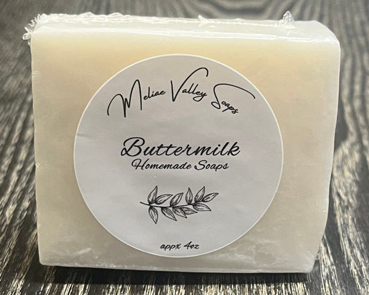 A white bar of soap with a label on a wooden surface.