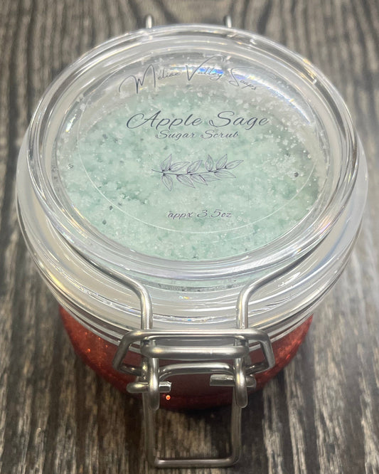 Clear round jar with a sticker on top. You see through the jar to green sugar.