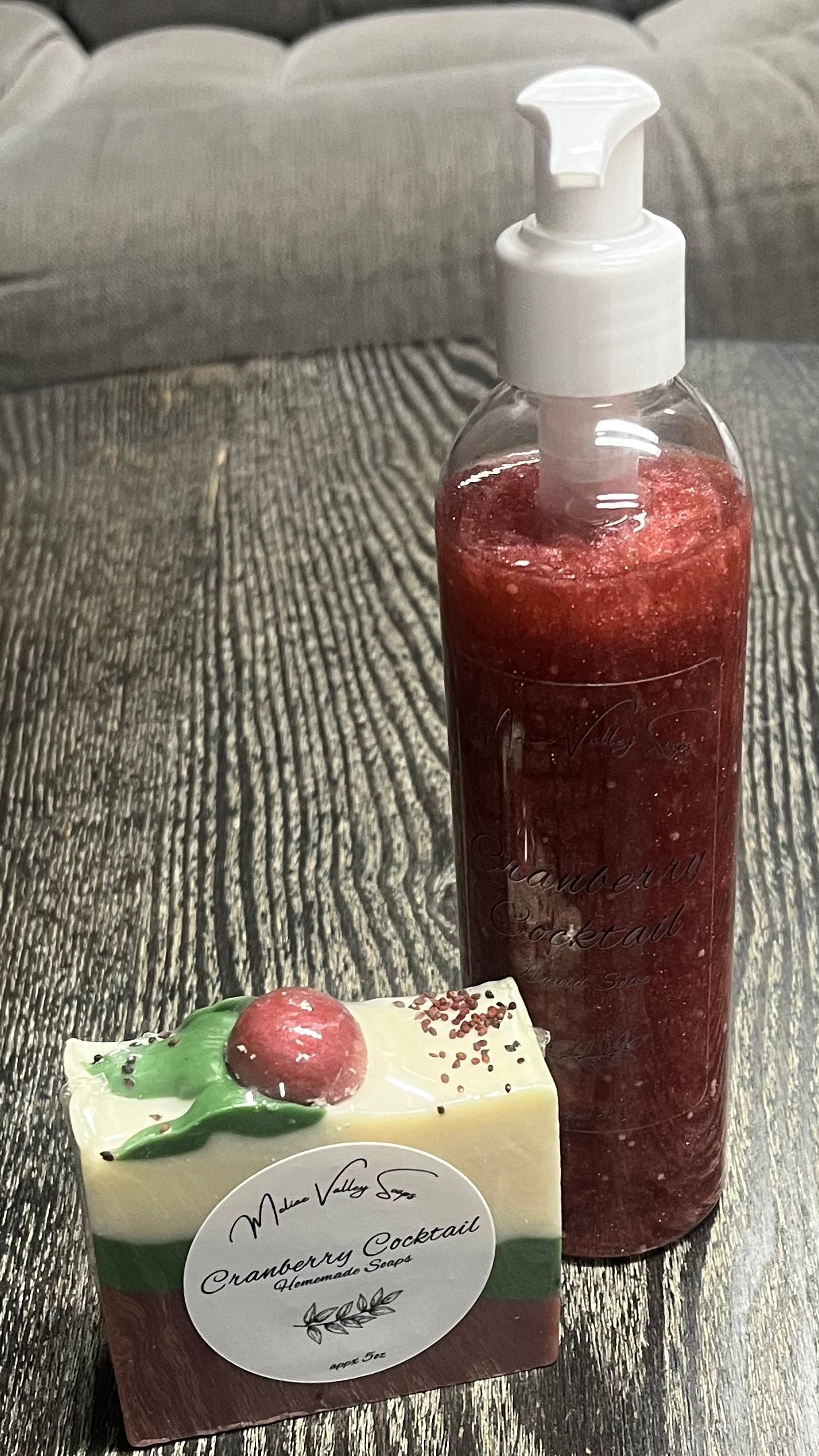 A set of beauty products, including a bottle and a bar on a textured surface.