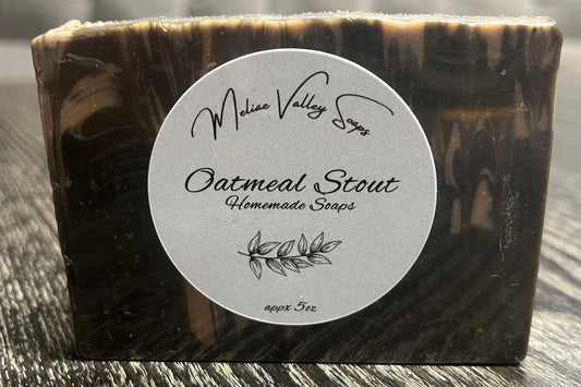 Bar of soap with a label on a wooden surface.