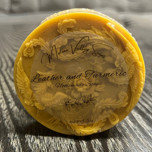 Yellow soap bar with a clear label on a wooden surface.
