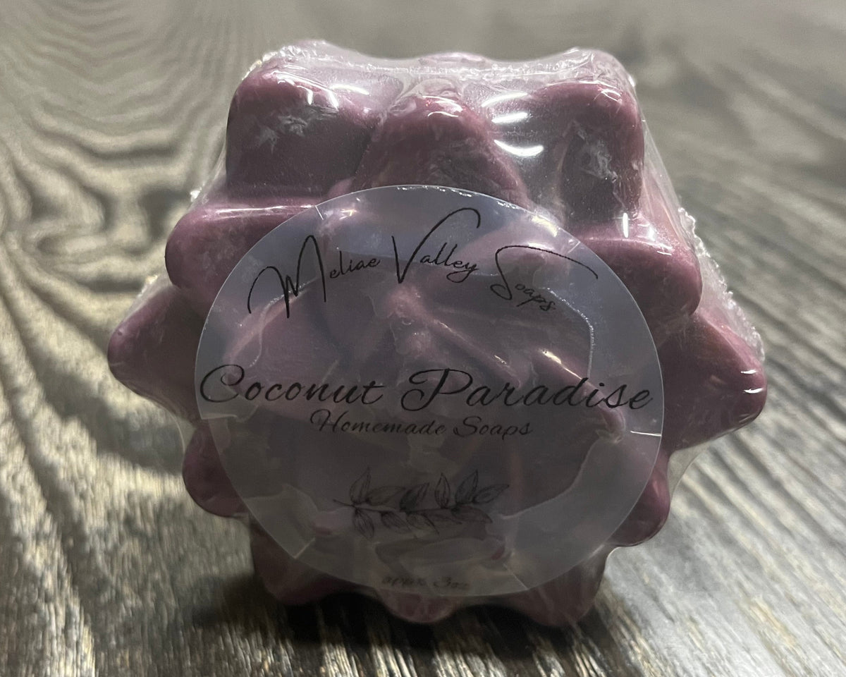 Packaged dark purple soap with a label.