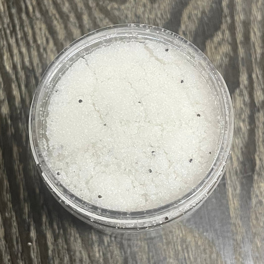 Jar of white sugar body scrub. You can slightly see a clear label on the front from this angle.