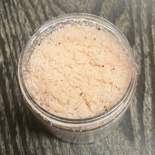 Jar of light brown sugar body scrub. You can slightly see a clear label on the front from this angle.