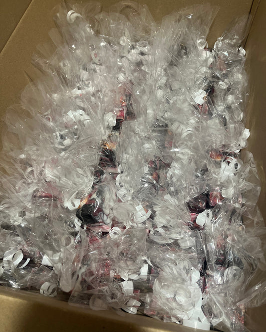 A box filled with clear plastic bags that have soap bars inside them. 