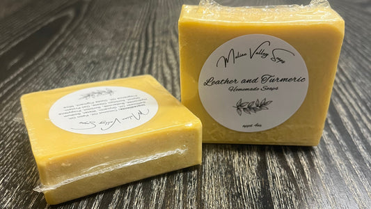 Yellow bar of soap with a label on a wooden surface.