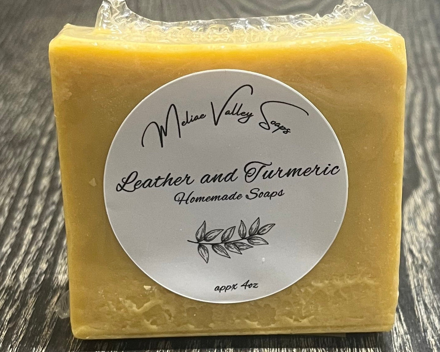 Yellow bar of soap with a label on a wooden surface.