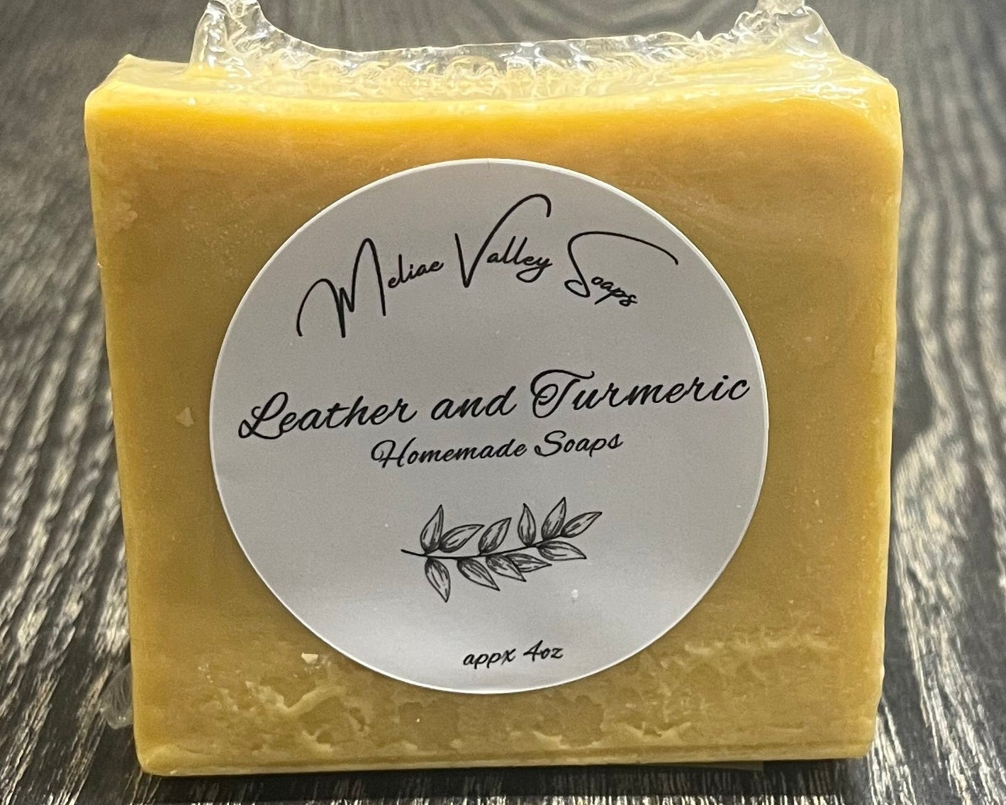 Yellow bar of soap with a label on a wooden surface.