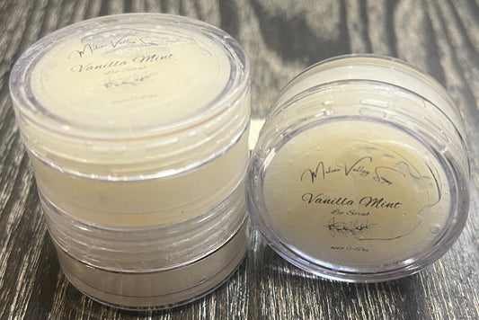 Three lip pots filled with white sugar. On the left-hand side, two of the lip pots are stacked on top of each other. On the right-hand side, the third lip pot is positioned on its side with its label facing the camera. 