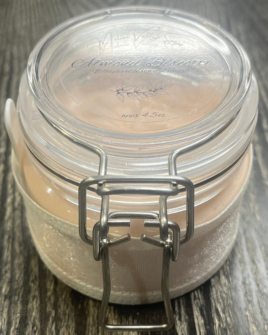 Clear round jar with a sticker on top. You see through to the jar to bronze body butter. 