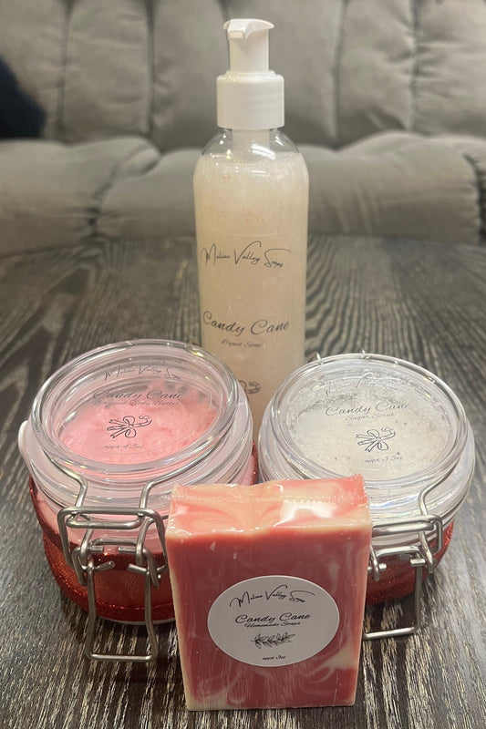 A set of beauty products, including a bottle, jars, and a bar on a textured surface.