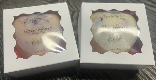 Two white boxes with heart-shaped lotion bars. 