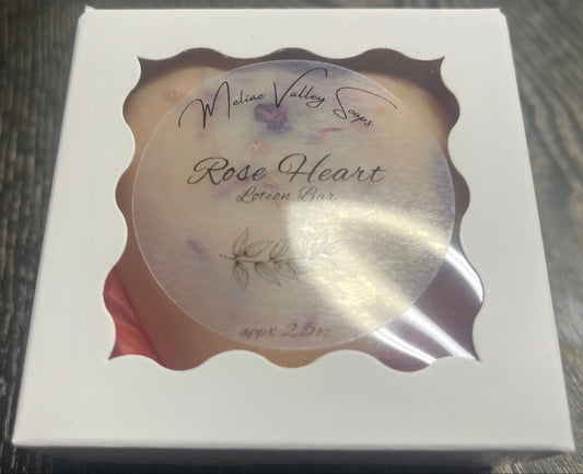 Lotion bar in decorative white box packaging.