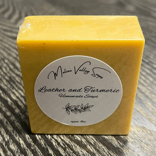 Yellow soap bar with a label on a wooden surface.