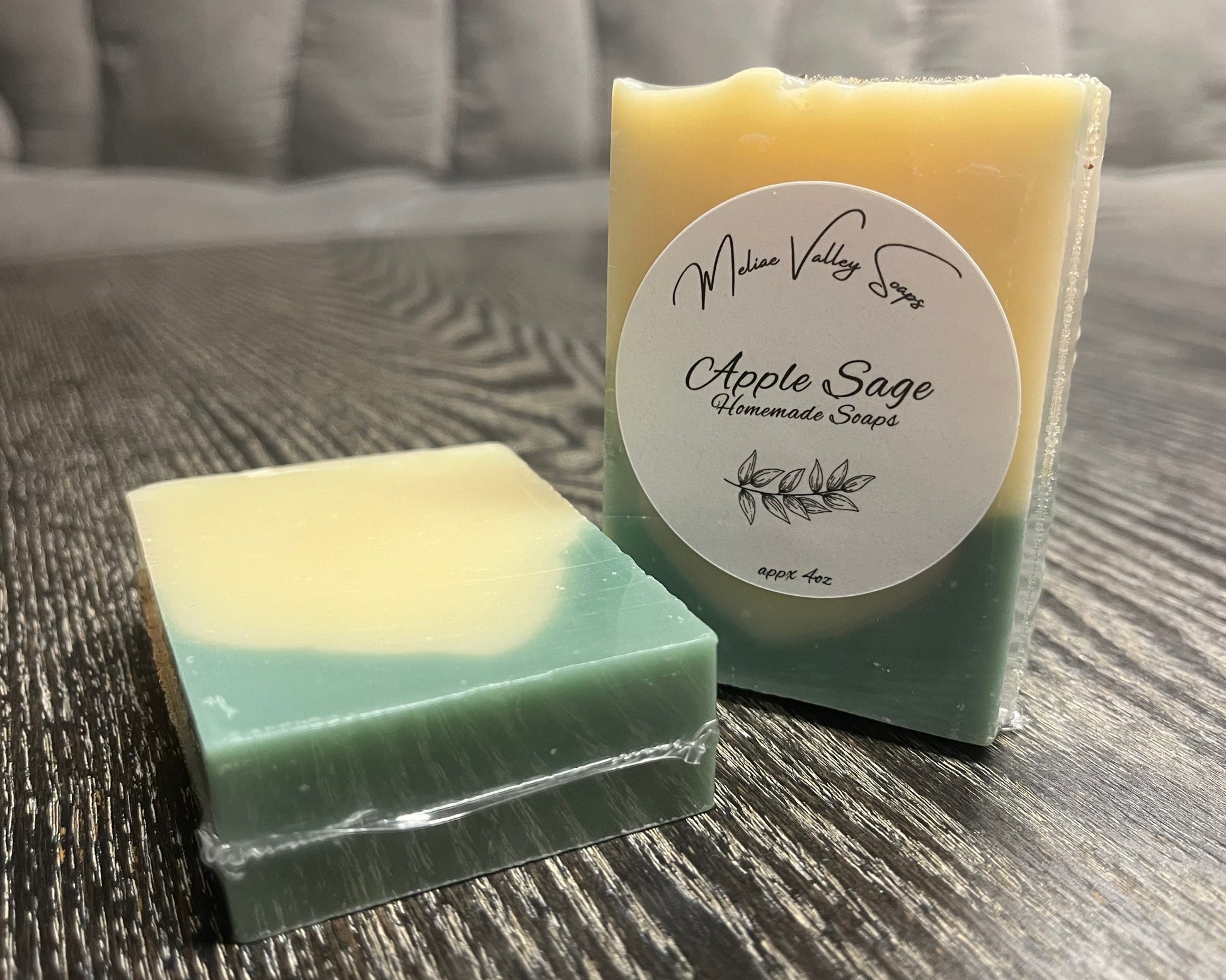 Two bars of soap, one upright with a white label, the other face down, showing the back and bottom of the bars. 