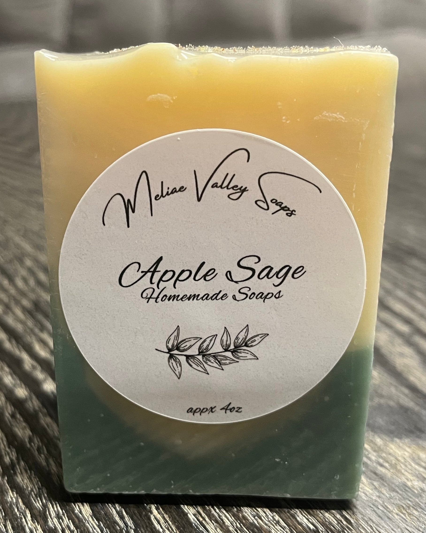 Bar of soap with a white label on a wooden surface. 