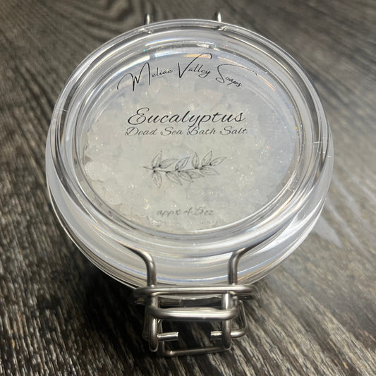 Jar of Eucalyptus Dead Sea Bath Salt on a wooden surface. 