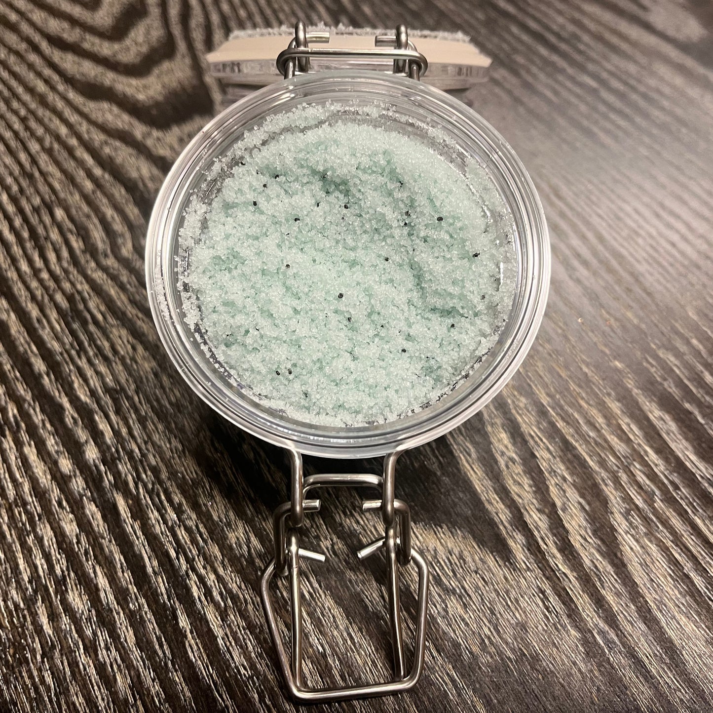 Jar of green sugar body scrub. 