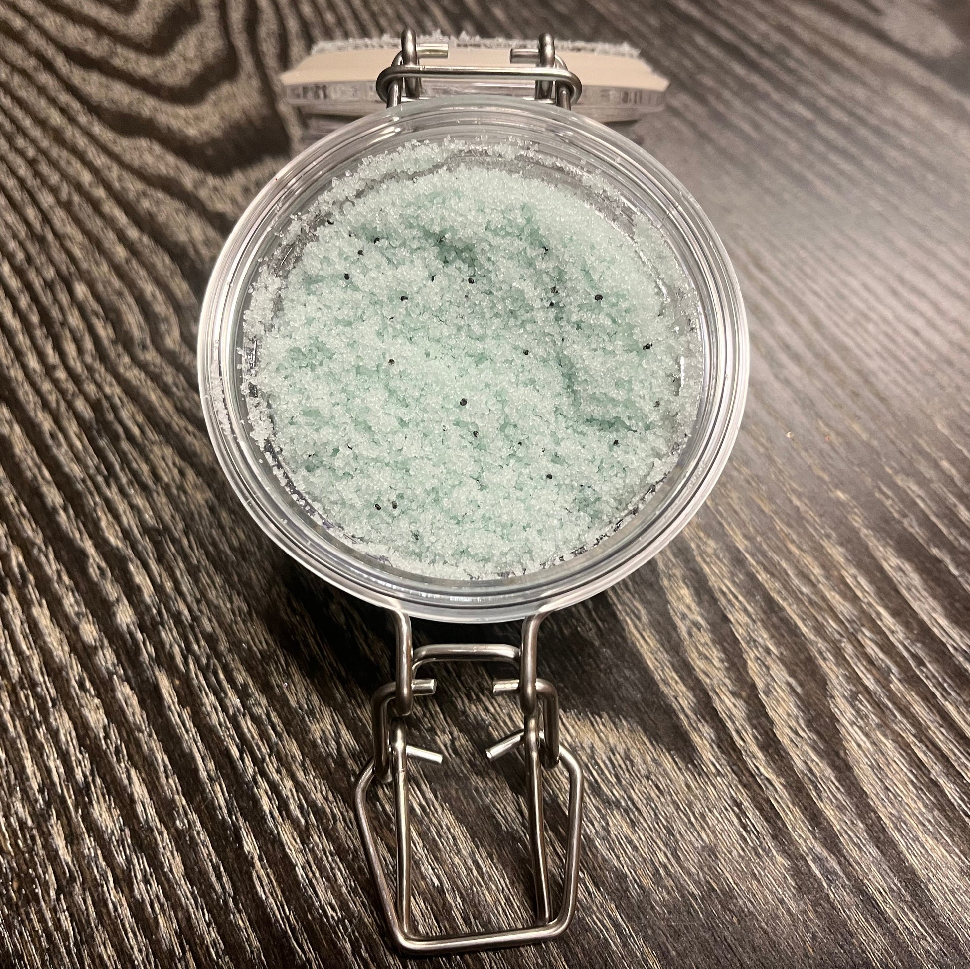 Jar of green sugar body scrub. 