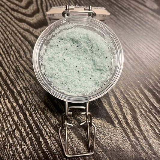 Jar of green sugar body scrub. 