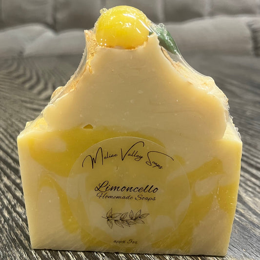 Yellow soap bar on a wooden surface. 