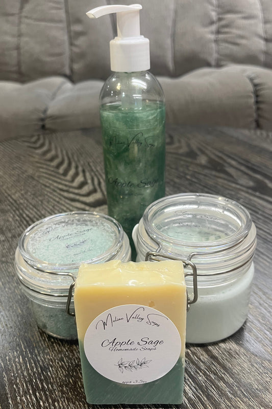 A set of beauty products, including a bottle, jars, and a bar on a textured surface.