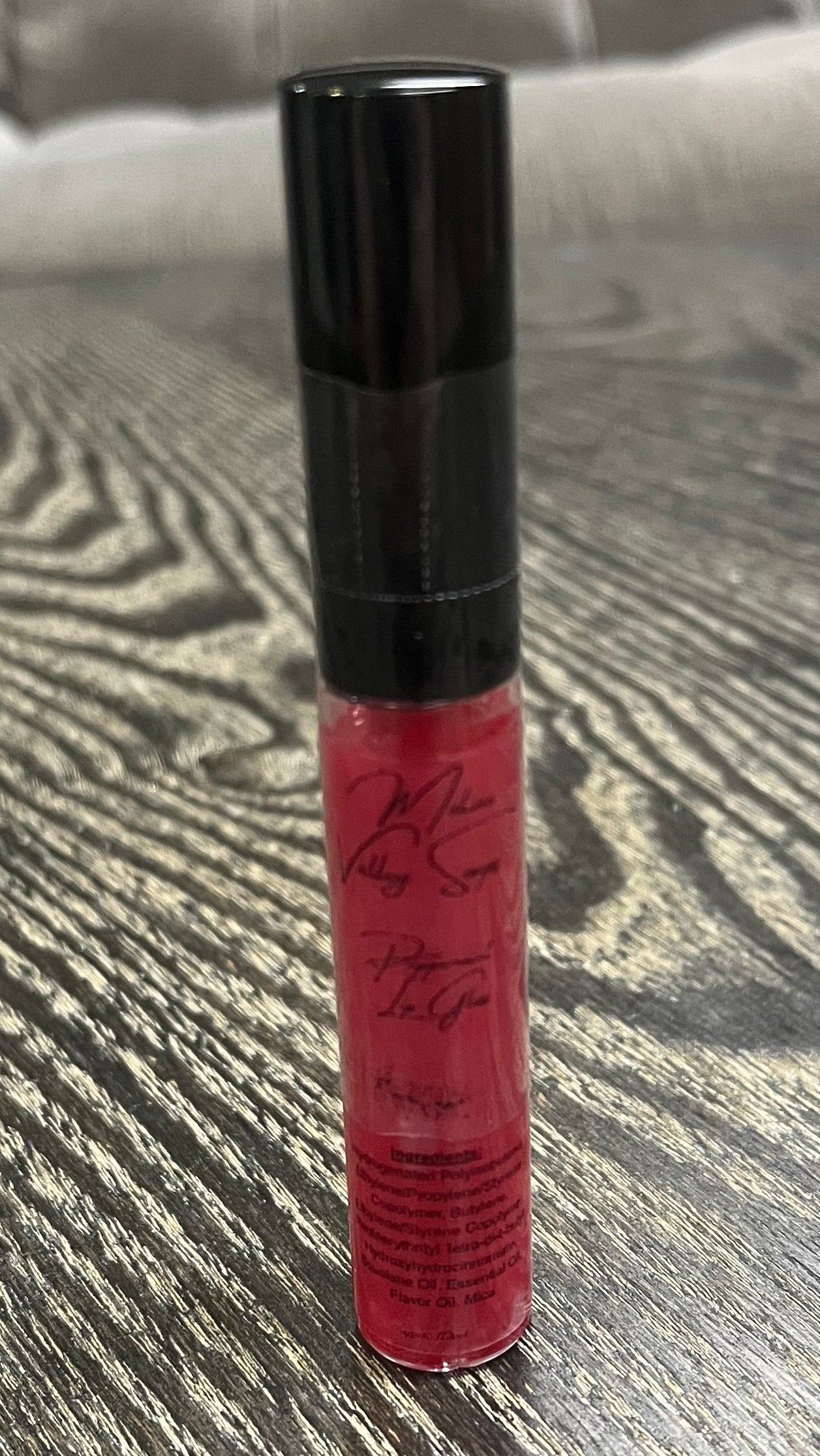 A red tube of lip gloss. 