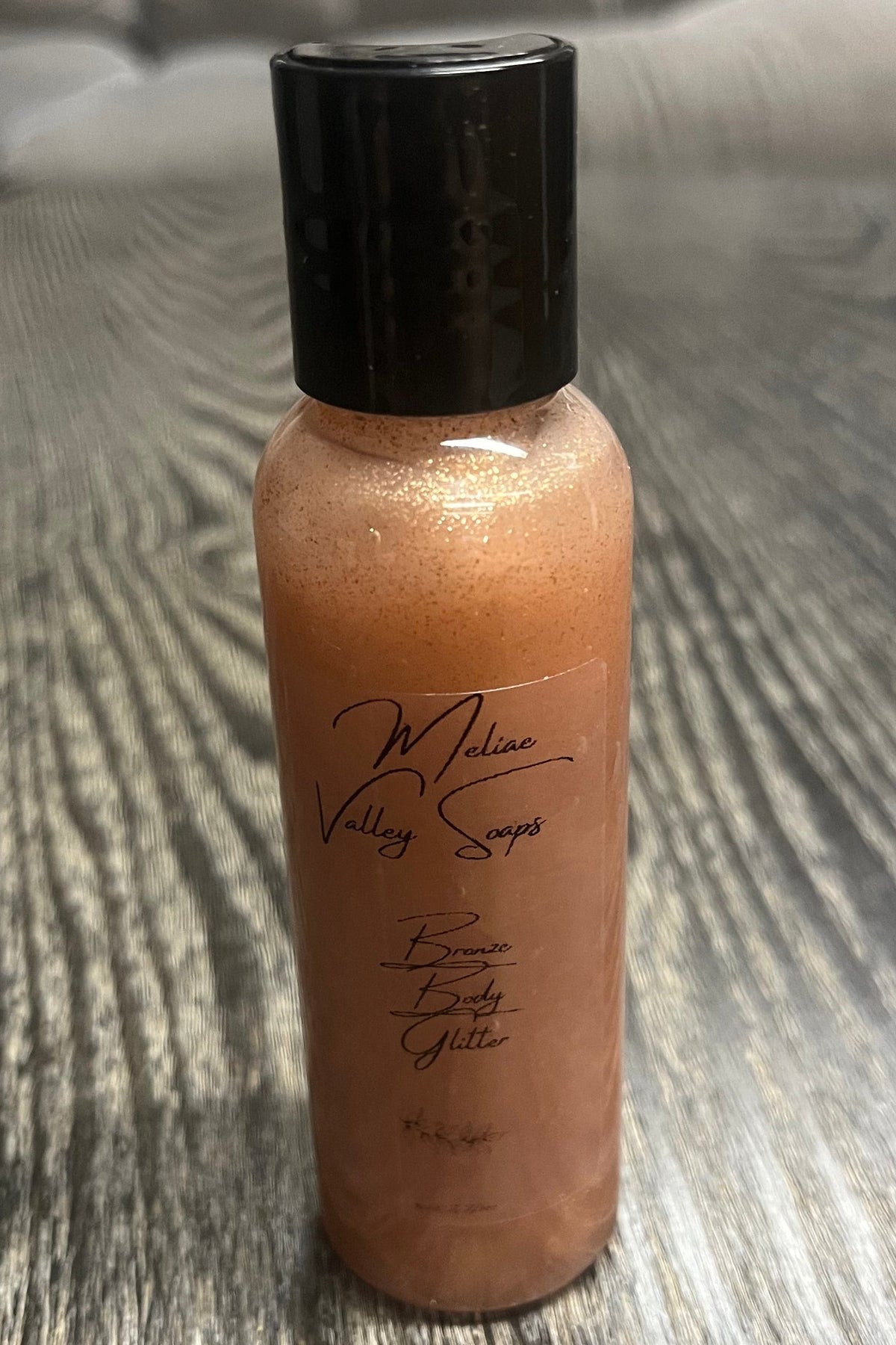 A small bottle of bronze body shimmer.