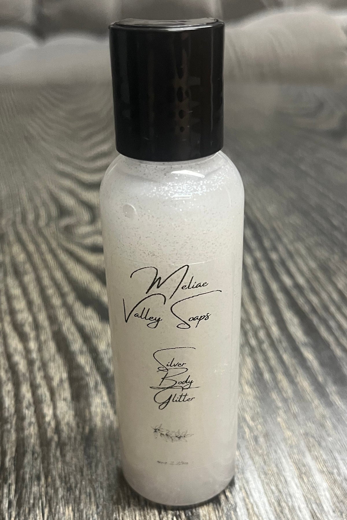 A small bottle of silver body shimmer.