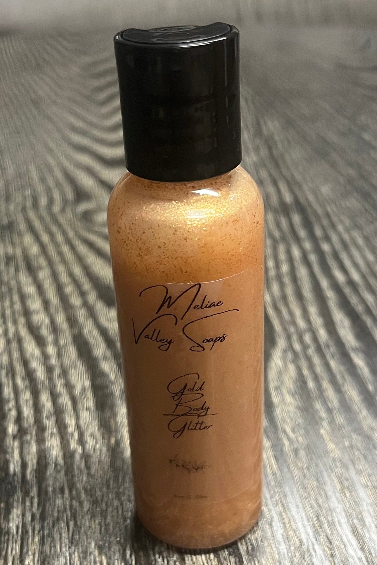 A small bottle of gold body shimmer.
