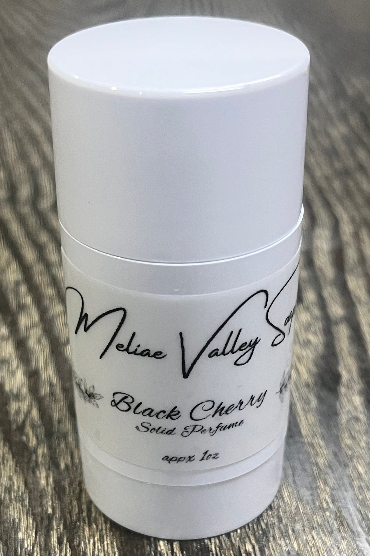 A white tube with a label on the front. 
