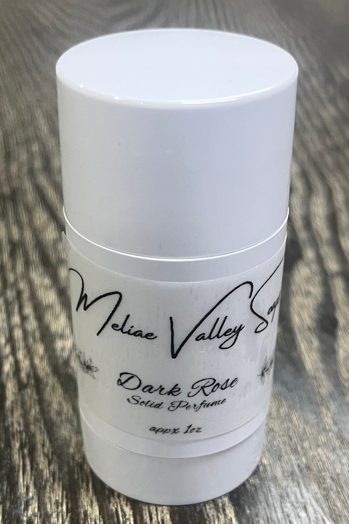 A white tube with a label on the front. 