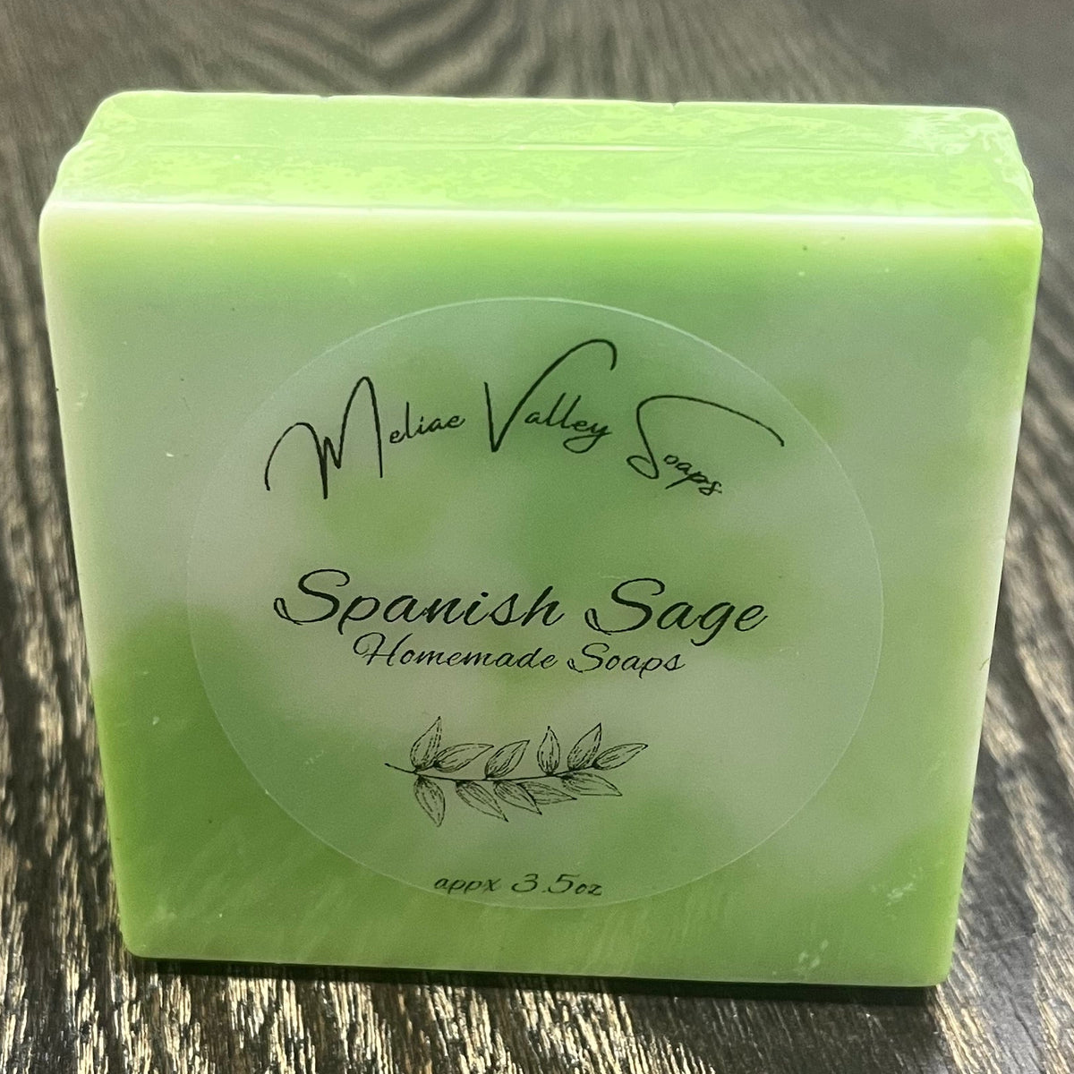 A green and white bar of soap. It has a clear label on the front. 