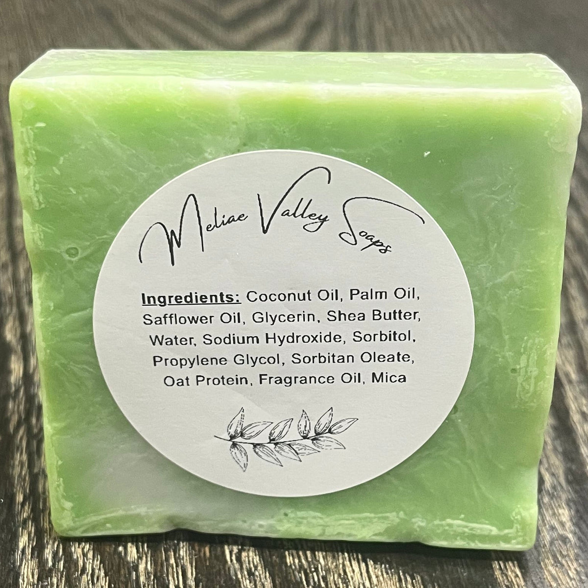 A green and white bar of soap. It has a  white ingredients label. 