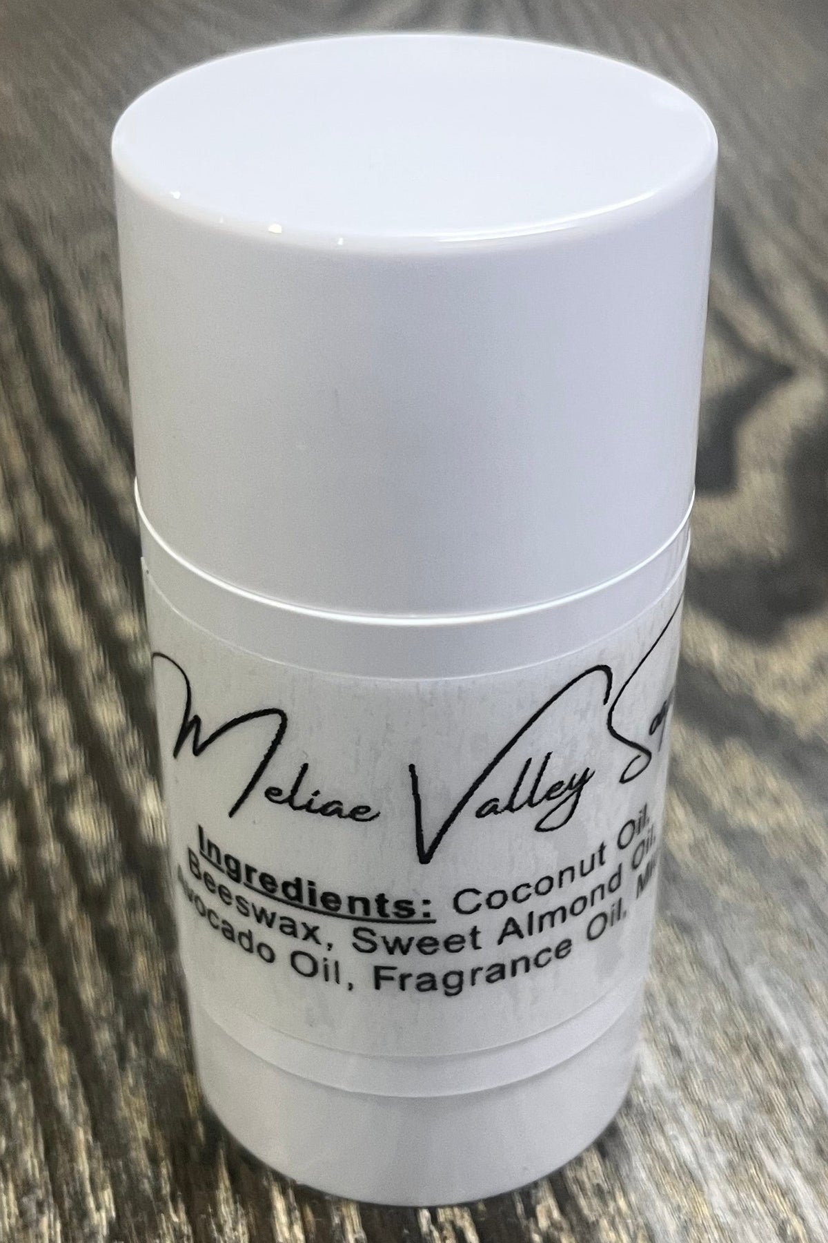 A white tube with an ingredients label on the back. 